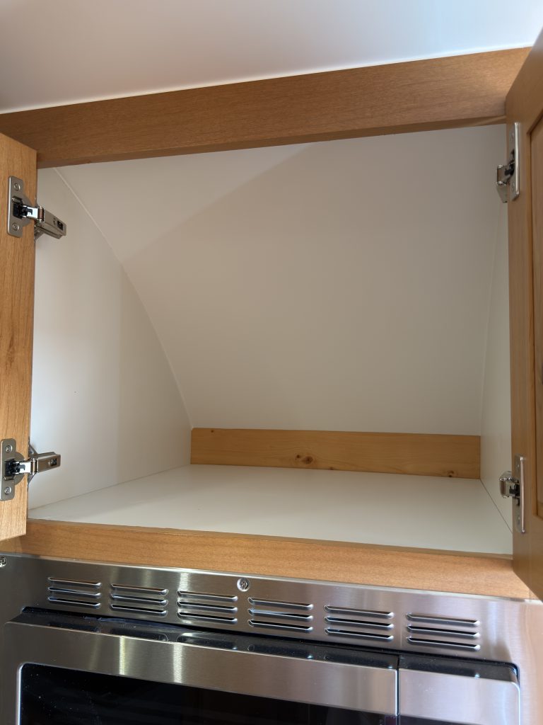 Open upper cabinet storage in Nielsen Camp #133