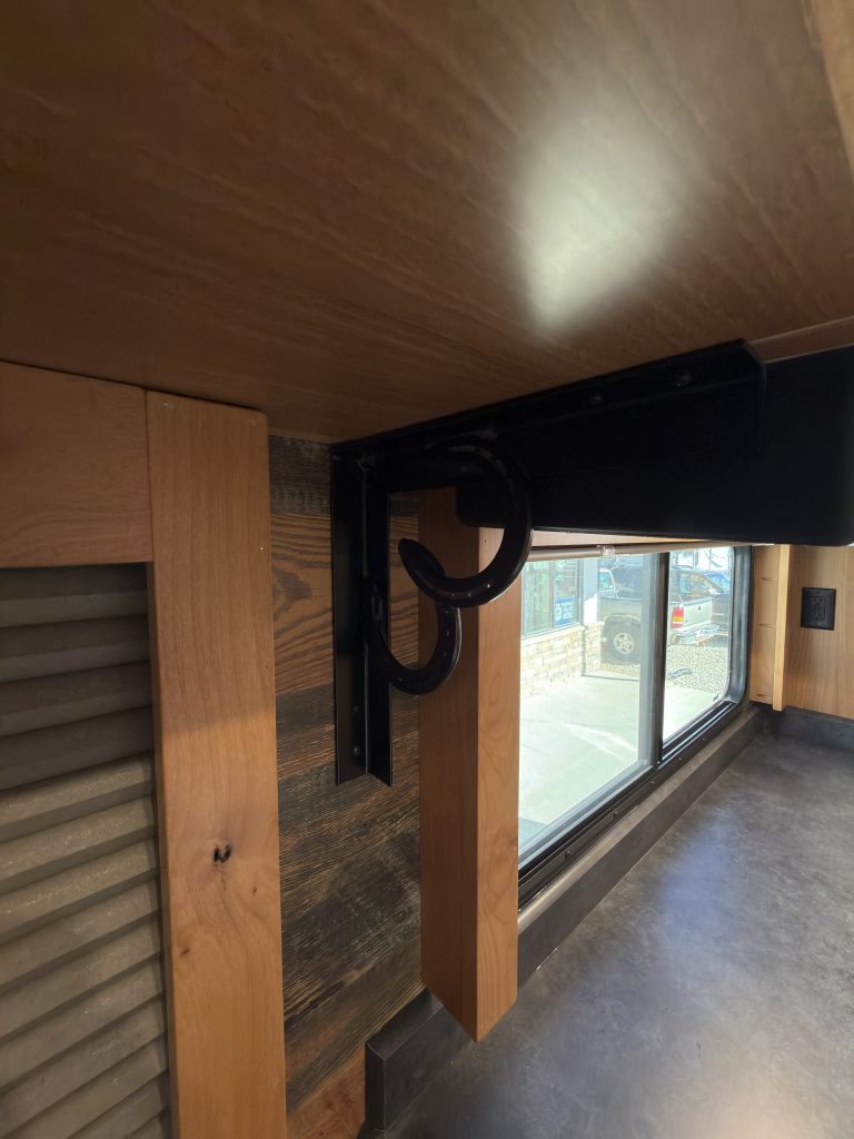 Horseshoe bracket accent above a window shade in Nielsen Camp #133