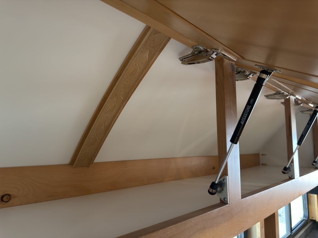 Gas-strut cabinet above the recliners in Nielsen Camp #133