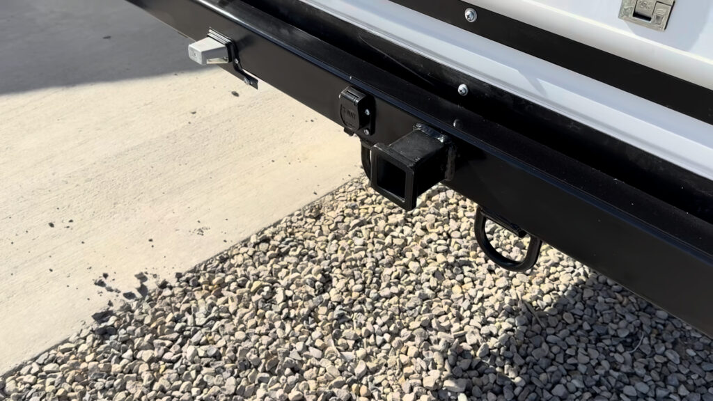 Square receiver and two metal loops on the black rear bumper of Plankis Camp #124.