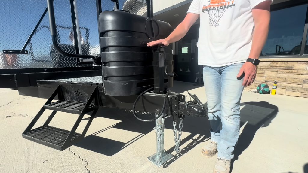 Close view of the black propane tank cover beside the fold-up entry steps.