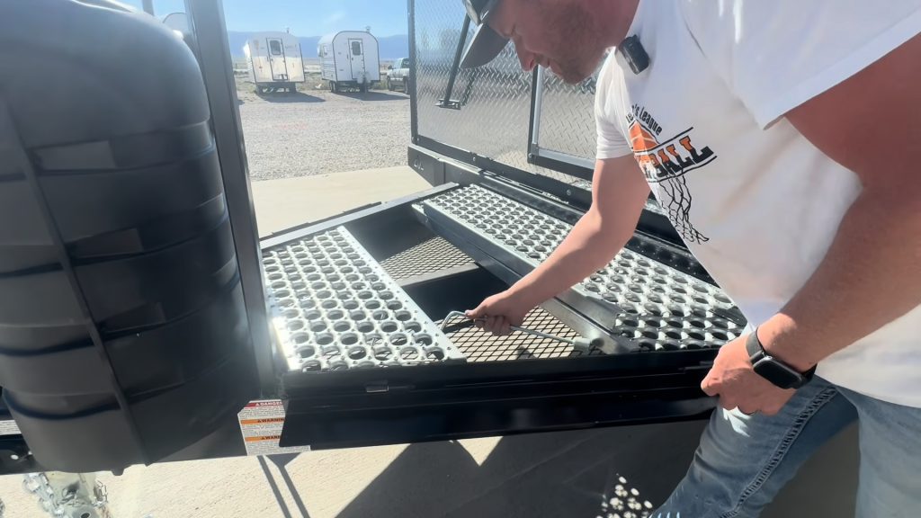 Presenter showing the open tongue storage beneath removable metal decking.