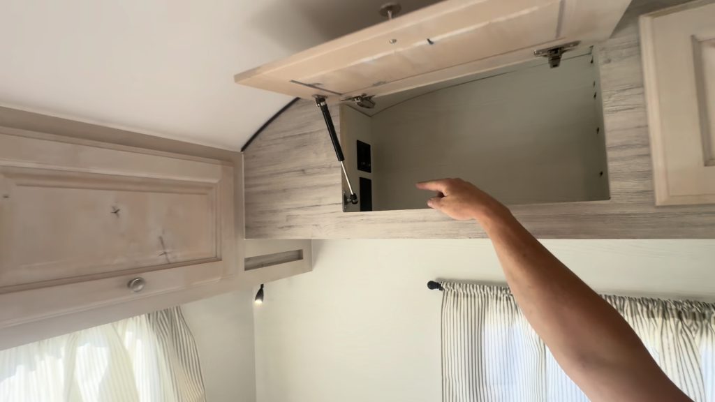 Open upper cabinet above the rear sleeping area.