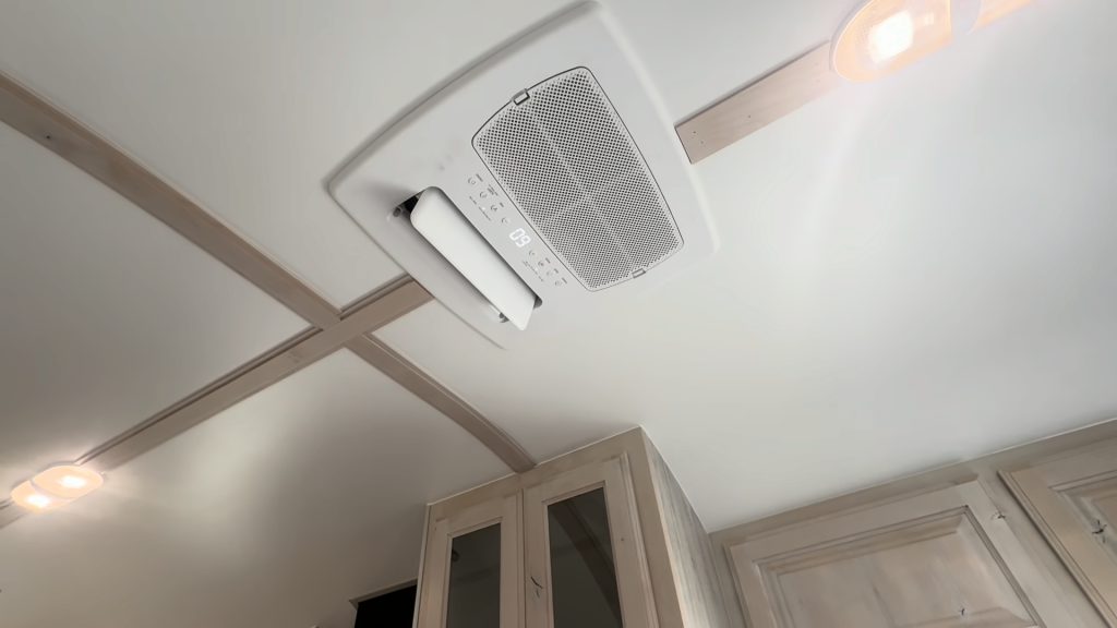 Upward view of the ceiling air-conditioning unit, vent, and lighting.