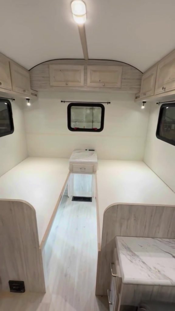 Portrait view of two Twin XL beds separated by a center nightstand.
