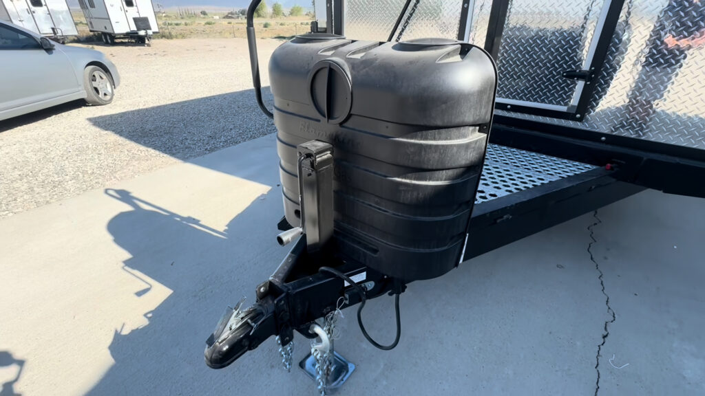 Close view of the propane tank cover on the Kendall Camp tongue beside the hitch and front deck.
