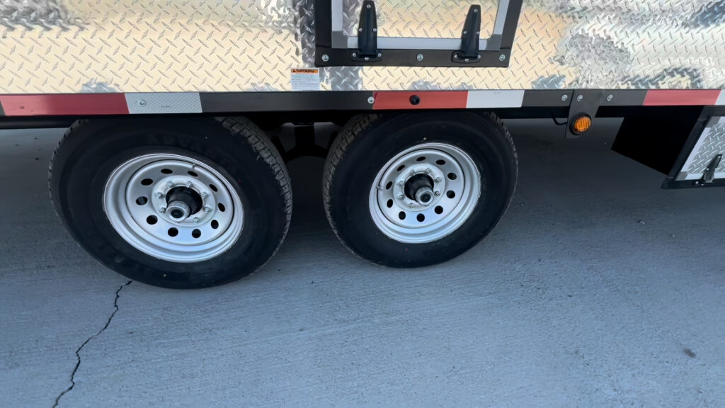 Close view of the Kendall Camp tandem wheels and tires beneath the sidewall.