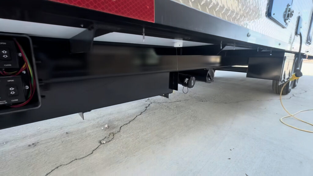 Low view beneath the Kendall Camp showing part of the frame and underbody components.