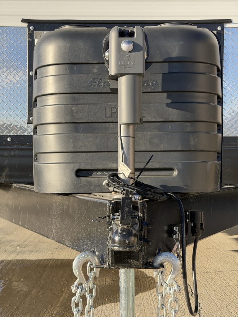 Front view of the propane cover, electric jack, and hitch assembly in Keulen Camp #132.