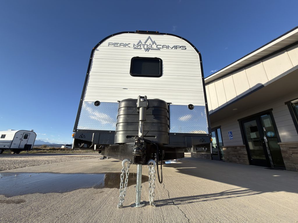 Low front angle showing the curved roofline and towing assembly in Keulen Camp #132.