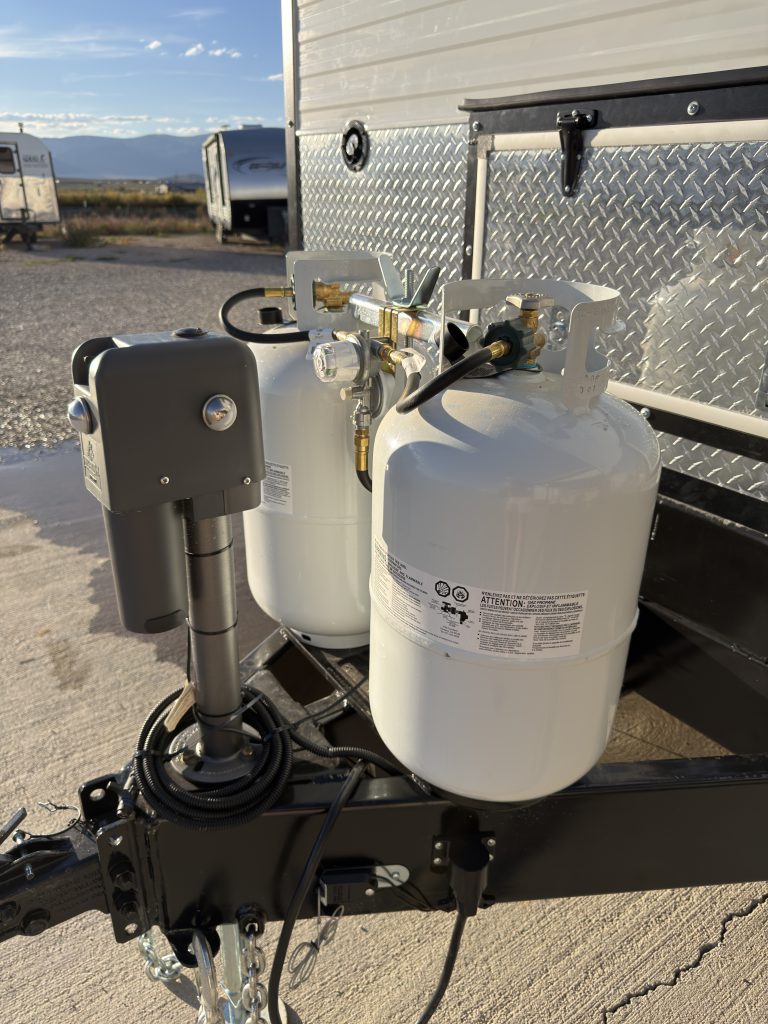 Two propane cylinders with connecting hoses and regulator in Keulen Camp #132.