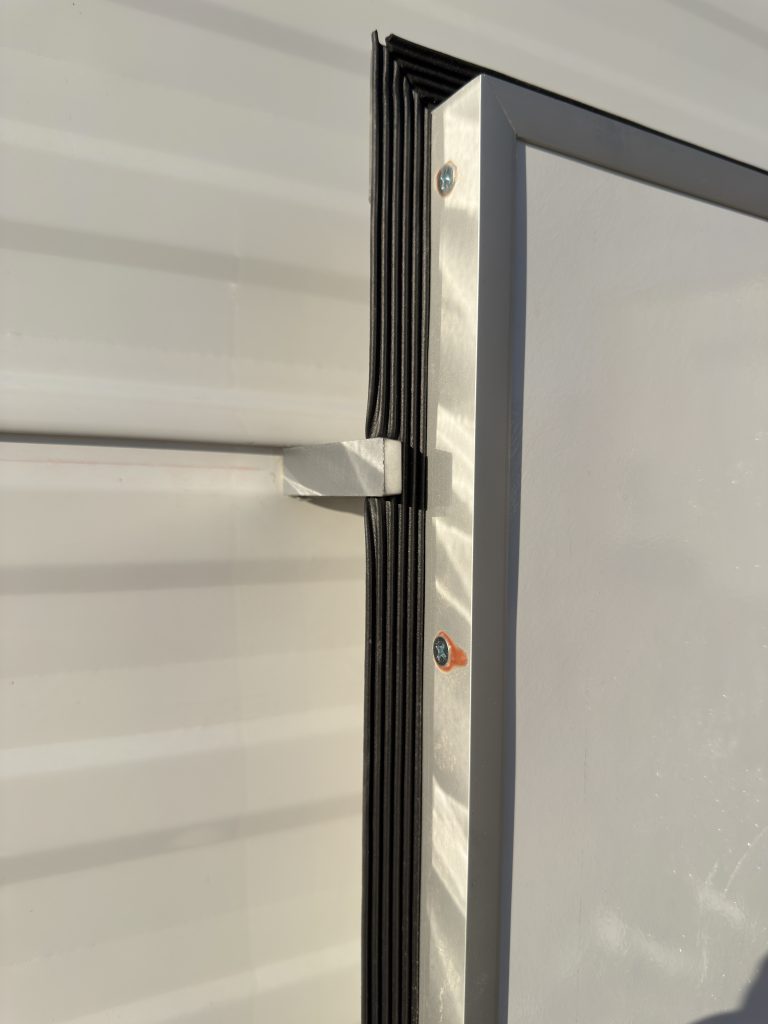 Exterior hatch retaining hardware beside the siding in Keulen Camp #132.
