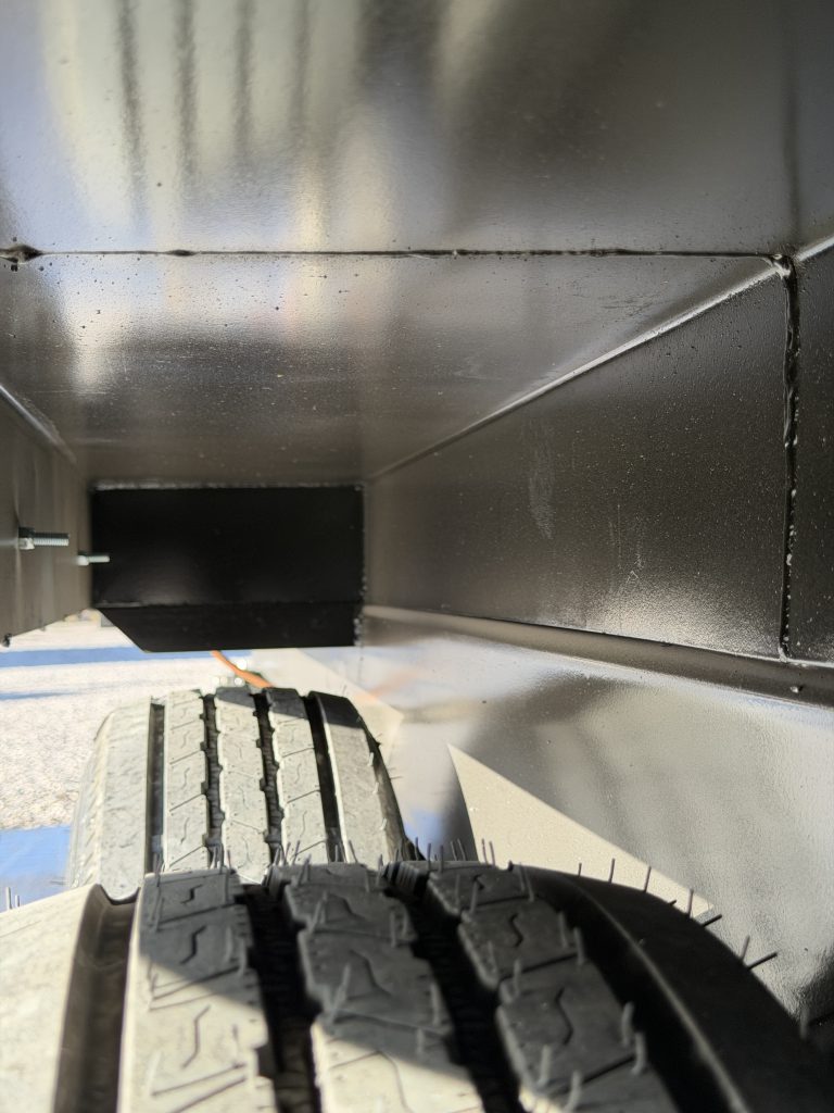 Close view of a tire beneath the black wheel housing in Keulen Camp #132.