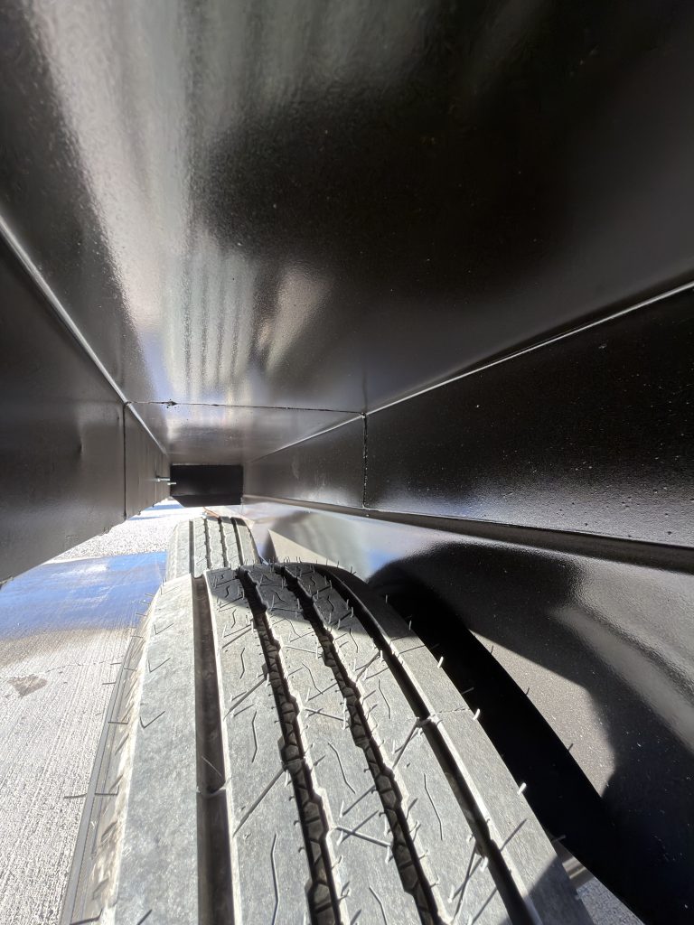 Close view along the tire tread beneath the wheel well in Keulen Camp #132.