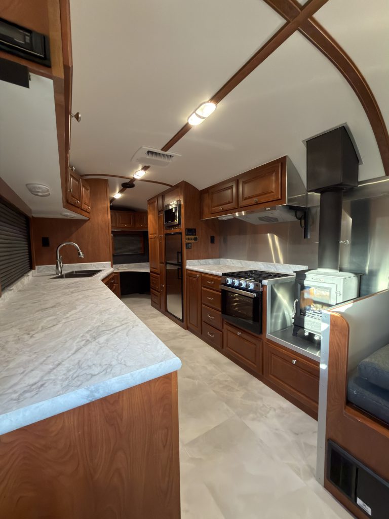 View along the countertop toward the range and wood cabinetry in Keulen Camp #132.