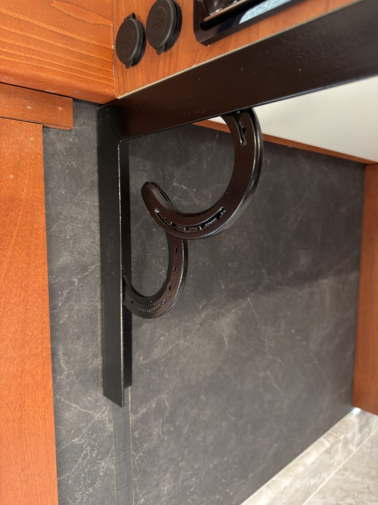 Welded horseshoe accents beneath the wood trim in Keulen Camp #132.