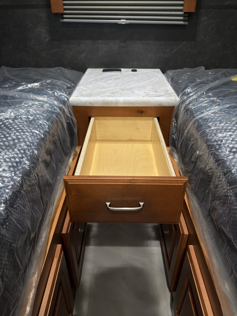 Open drawer in the central nightstand between the mattress platforms in Keulen Camp #132.