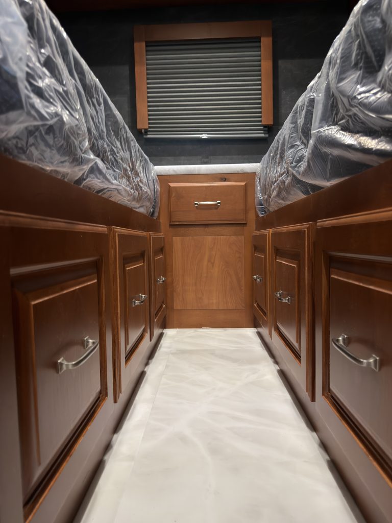 Lower drawers and wood cabinetry beneath the mattress platforms in Keulen Camp #132.