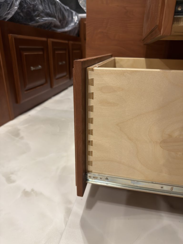 Close view of an open drawer showing dovetail construction and its runner in Keulen Camp #132.