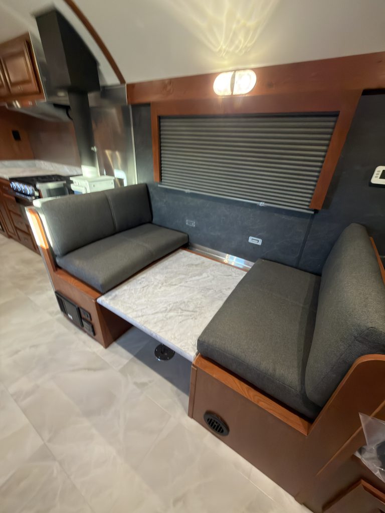 Dinette table lowered between the upholstered seats in Keulen Camp #132.