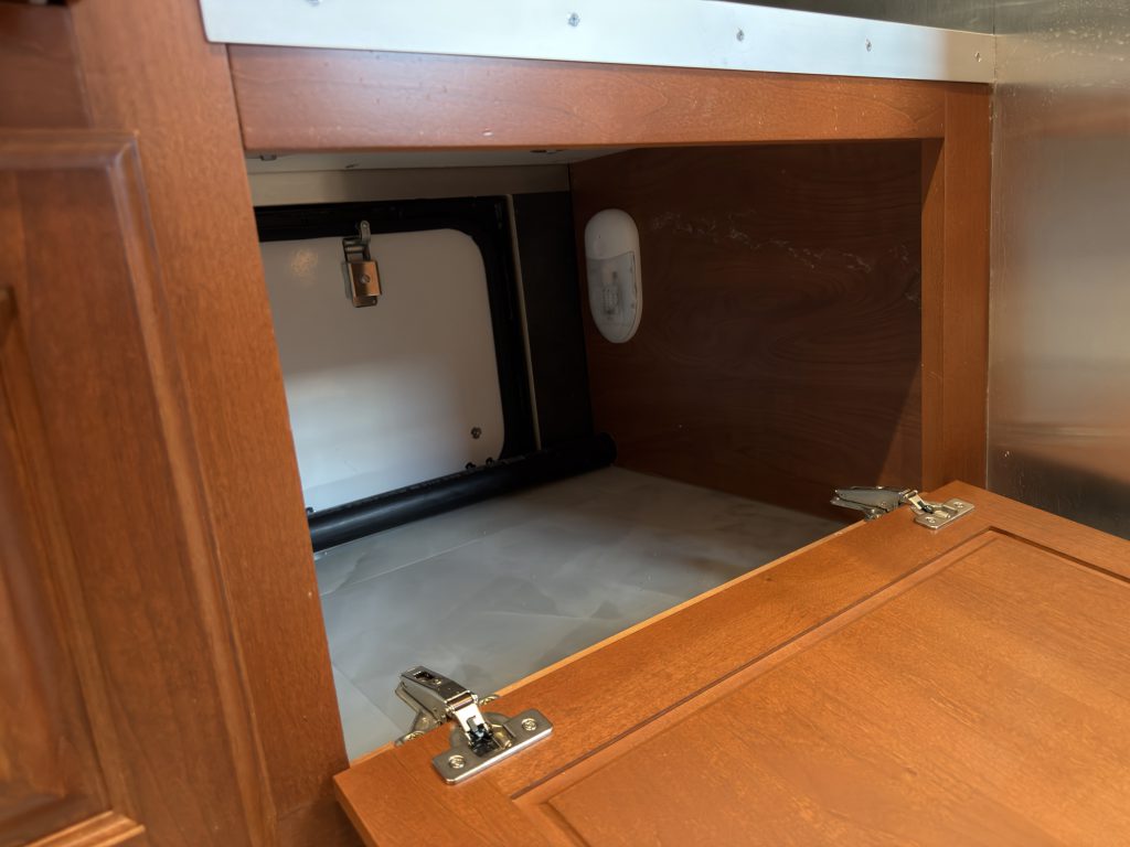 Open interior access to the pass-through firewood storage box in Keulen Camp #132.