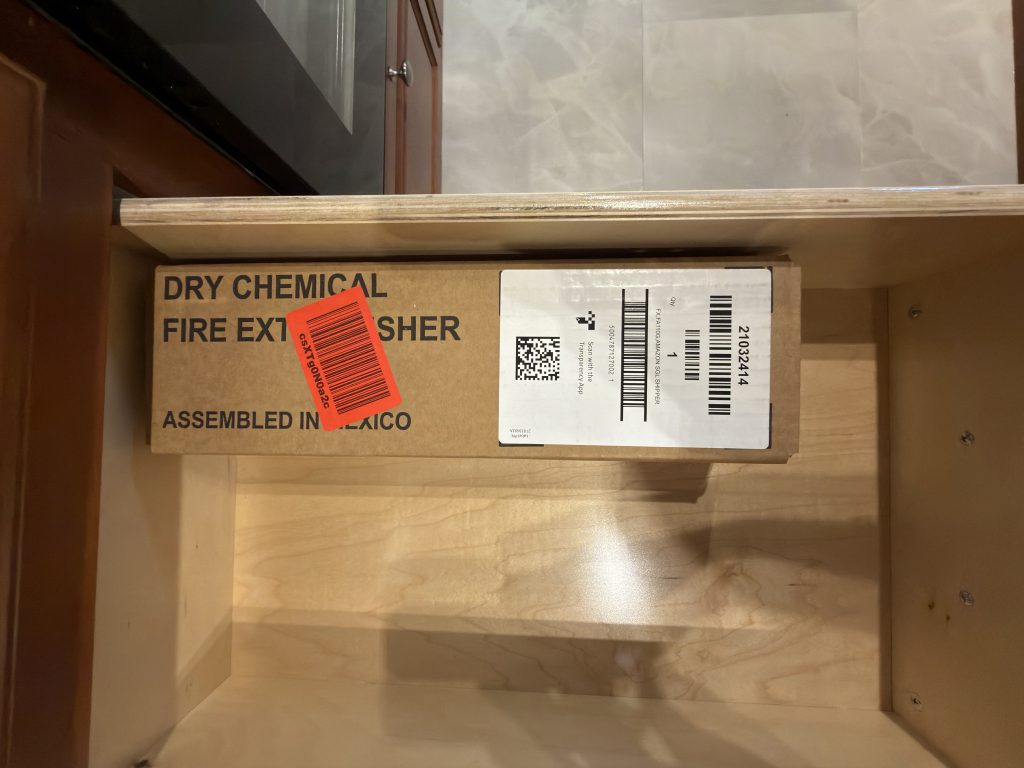 Packaged fire extinguisher inside an open drawer in Keulen Camp #132.