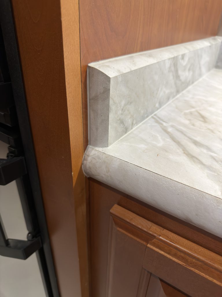 Close view of the countertop edge and short backsplash in Keulen Camp #132.