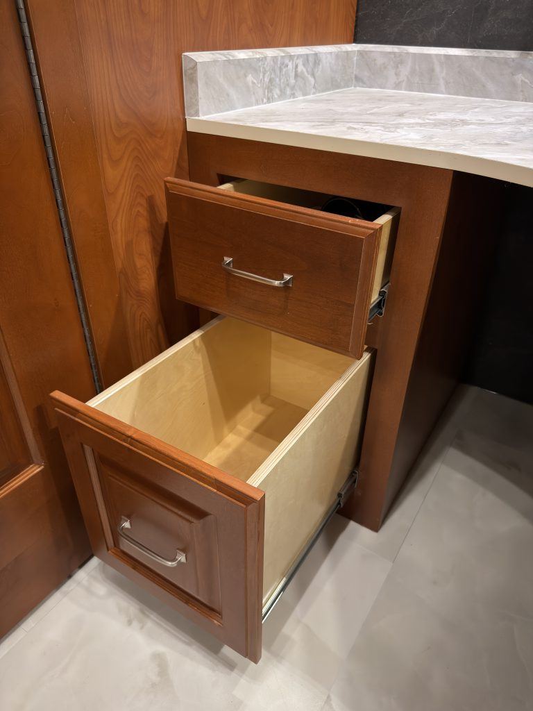 Two drawers extended beneath the office desk in Keulen Camp #132.
