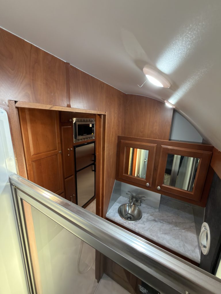 View across the shower enclosure toward vanity and doorway in Keulen Camp #132.
