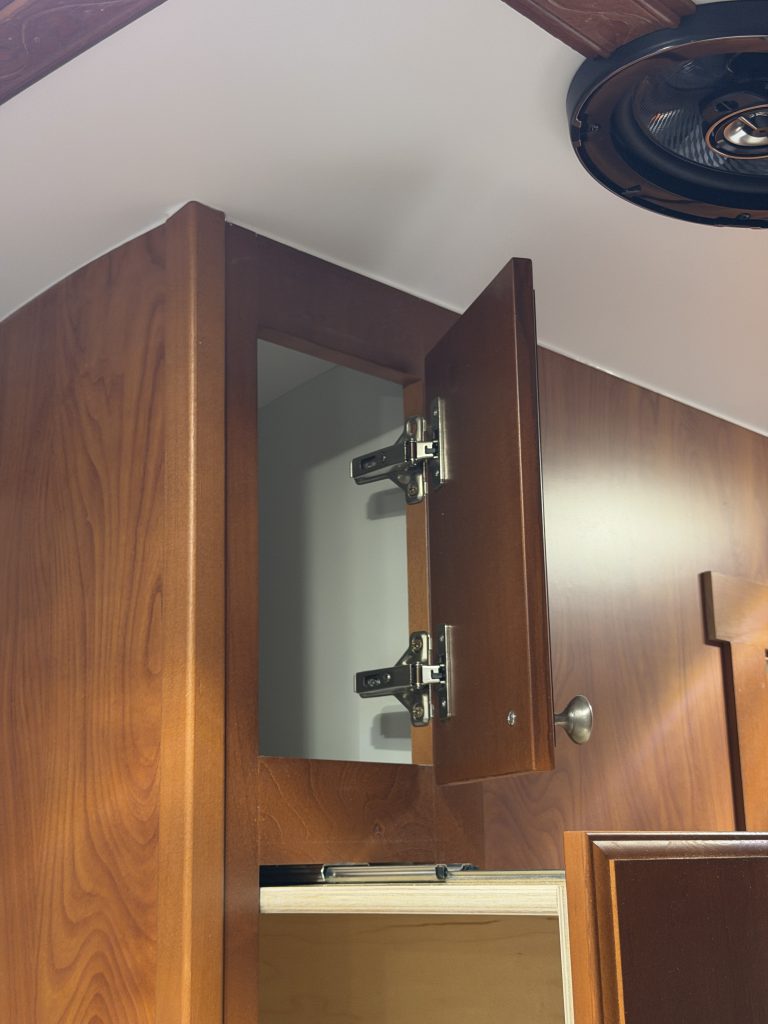Open upper closet compartment with hinges visible in Keulen Camp #132.
