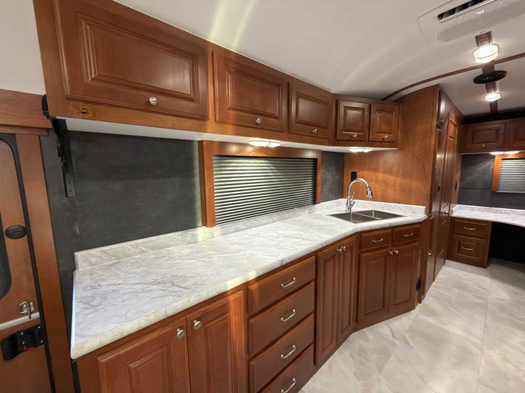 Long sink-side counter with drawers and overhead cabinets in Keulen Camp #132.