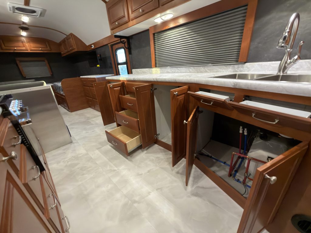 Sink-side doors and drawers open along the countertop in Keulen Camp #132.