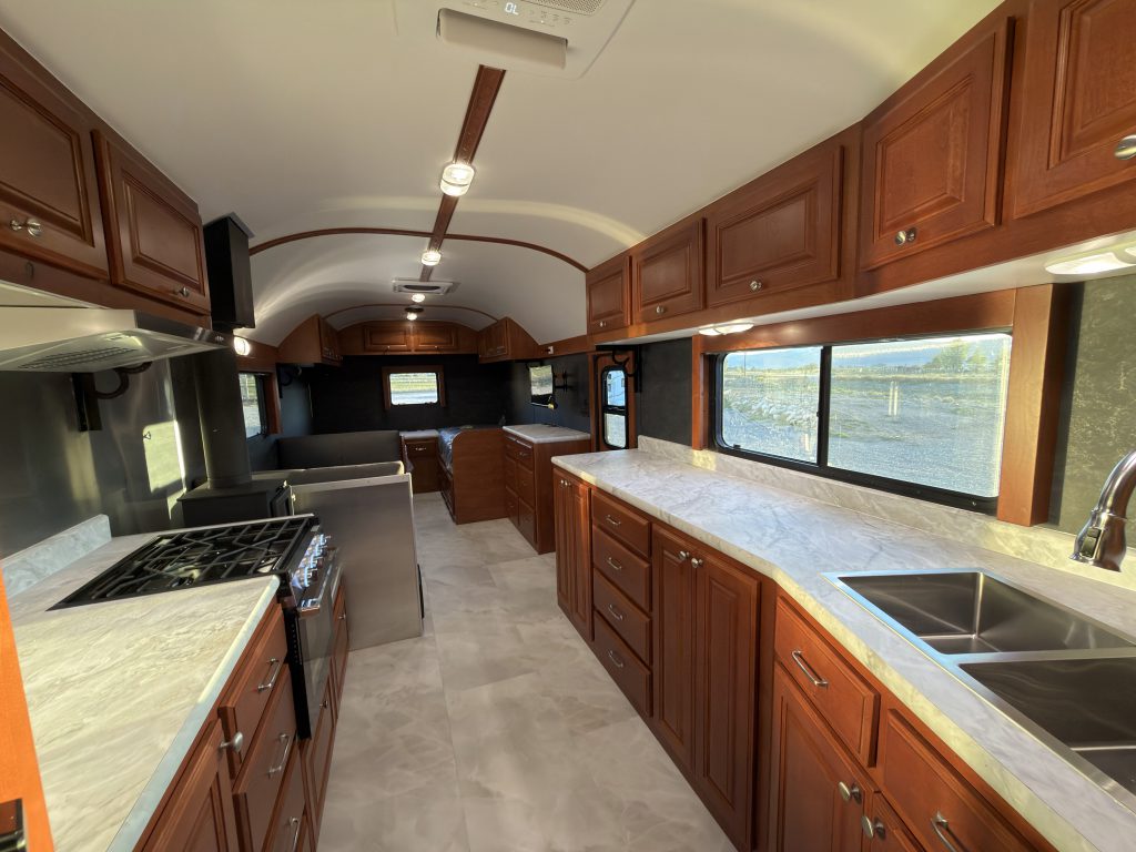 Wide cabin view with kitchen counters and uncovered windows in Keulen Camp #132.