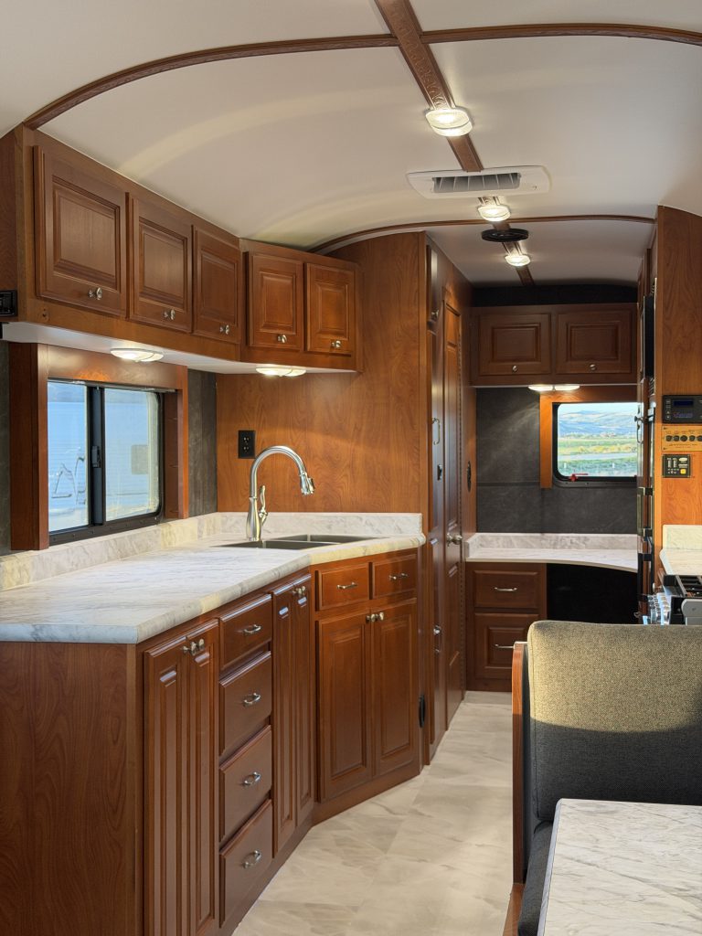 View along the sink-side cabinetry toward the rear workspace in Keulen Camp #132.
