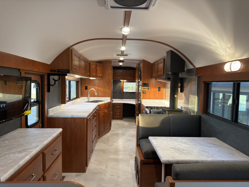 Kitchen cabinets and appliances beside the upholstered dinette in Keulen Camp #132.
