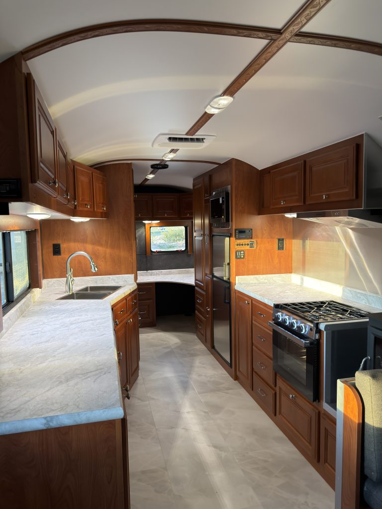 Kitchen aisle with overhead cabinets and range in Keulen Camp #132.