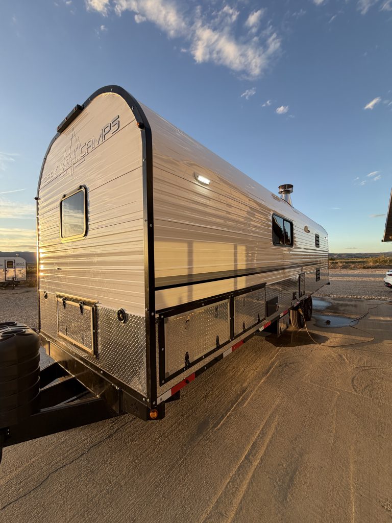 Service-side exterior with windows, access panels, and exterior light in Keulen Camp #132.