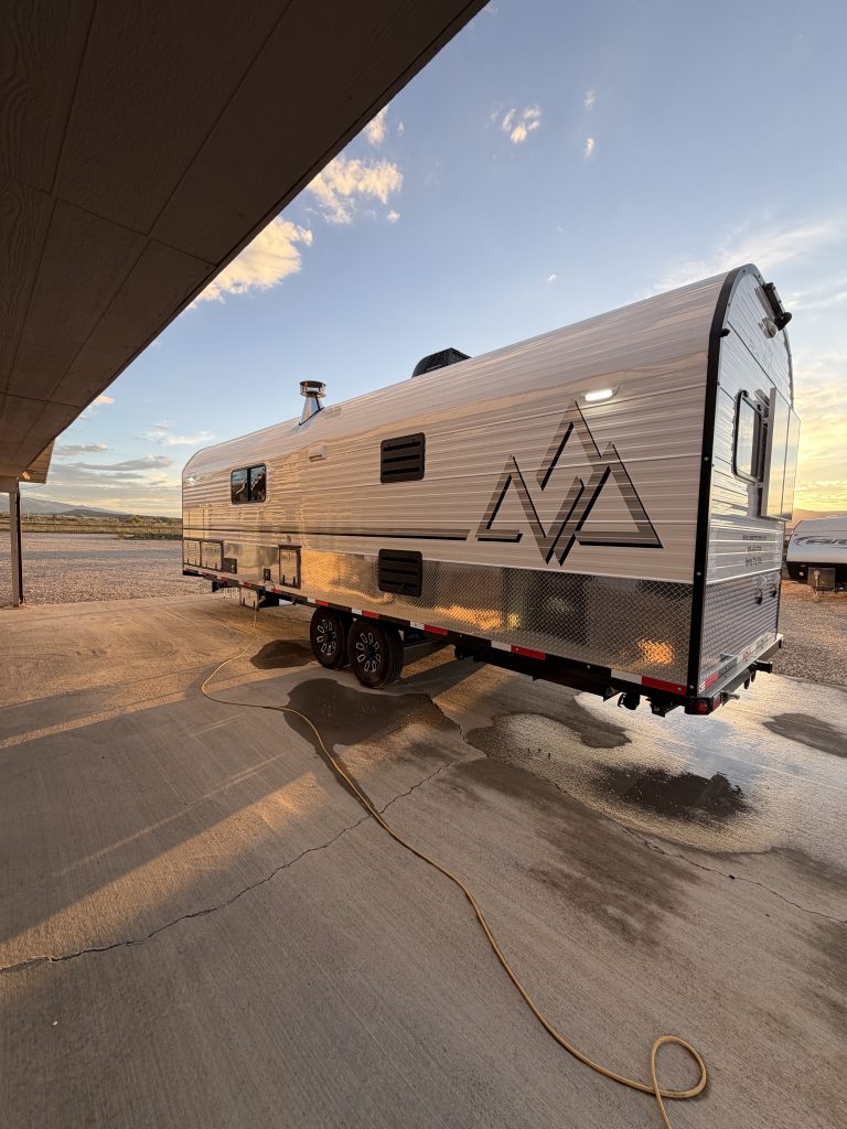 Rear three-quarter exterior with Peak graphics, windows, and tandem wheels in Keulen Camp #132.