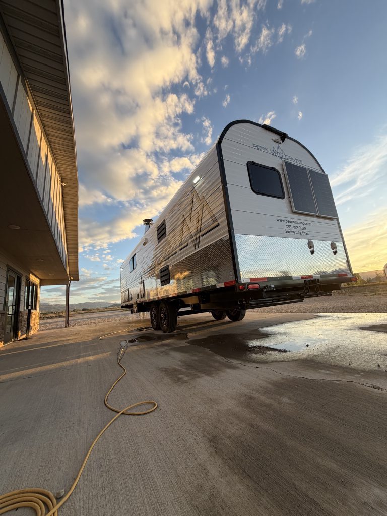 Low rear exterior angle showing two end windows and side graphics in Keulen Camp #132.