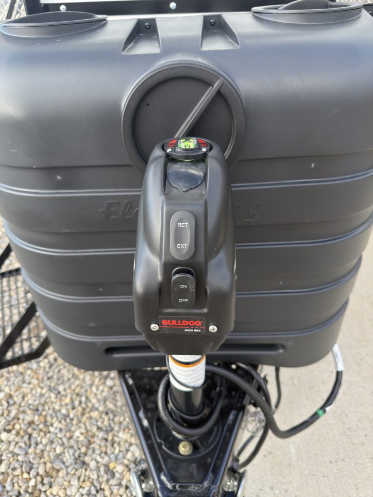 Van Niewkoop Camp #136: Controls on the Bulldog drop-leg electric tongue jack in front of the propane tank cover.