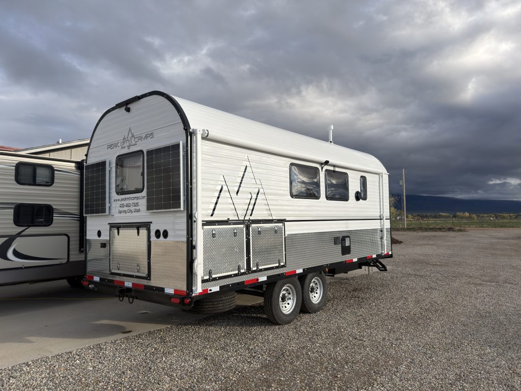 Rear corner view with side storage hatches and windows in Van Niewkoop Camp #136.