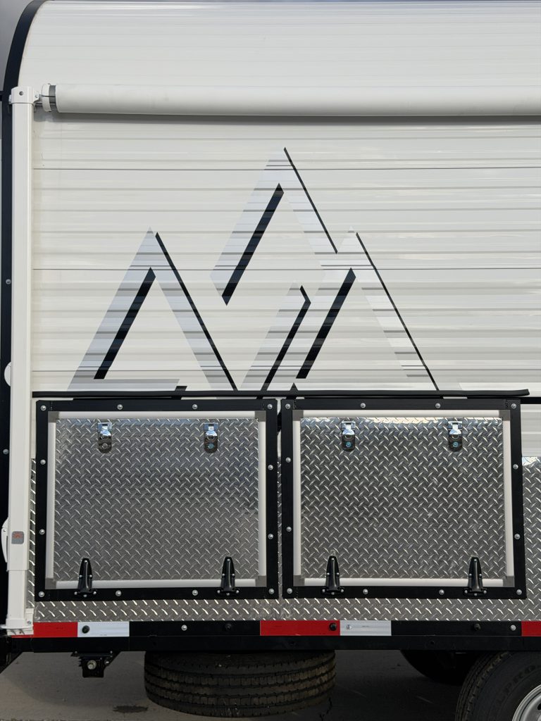 Van Niewkoop Camp #136: Peak mountain graphic above the diamond-plate curbside storage doors.