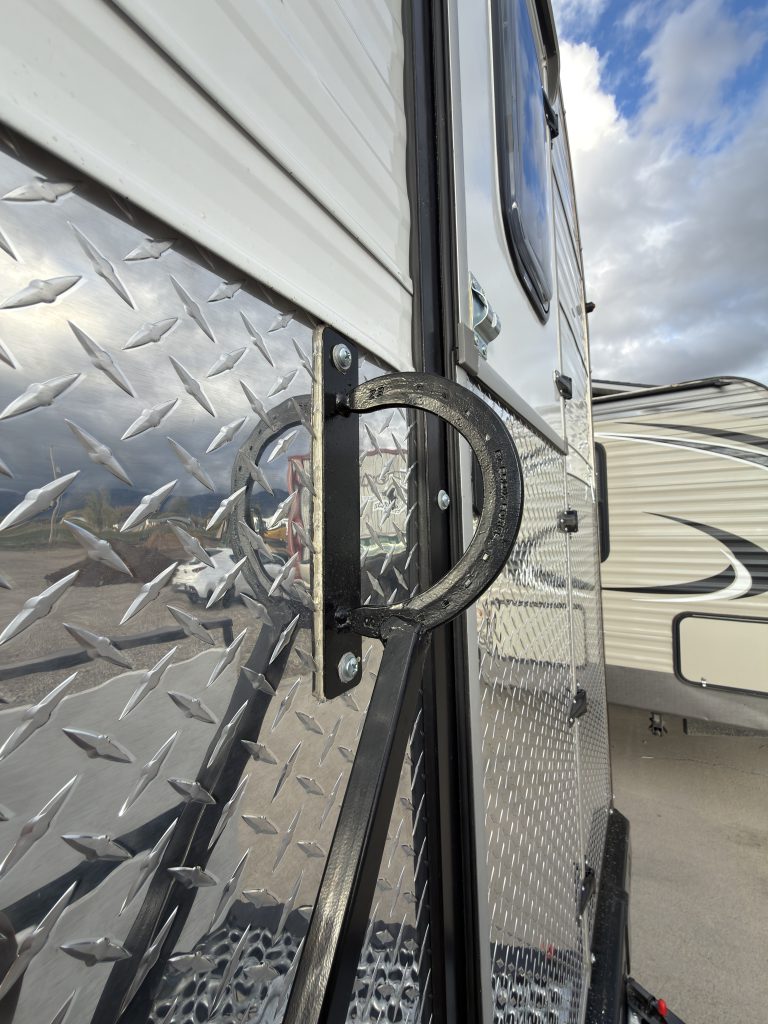 Close view of the grab handle beside the entry doorway in Van Niewkoop Camp #136.