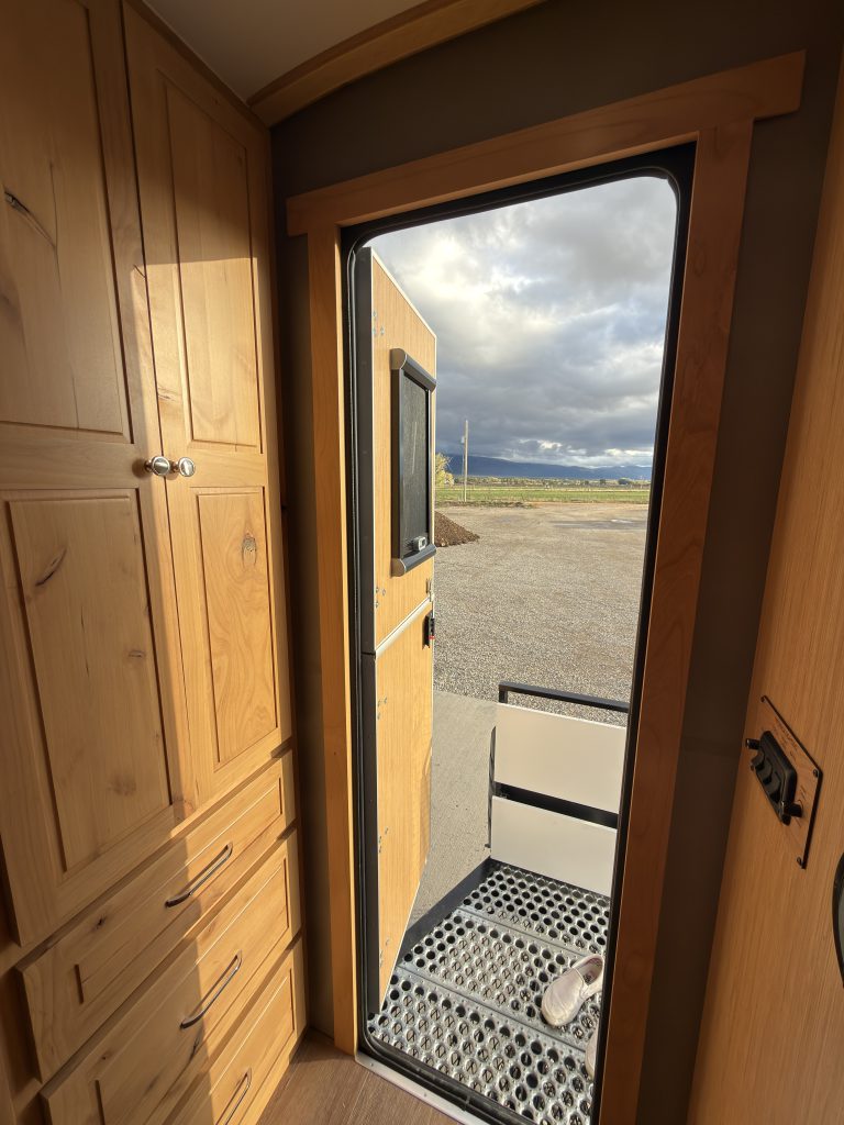 Van Niewkoop Camp #136: View from inside the camp through the open entry door to the landscape outside.