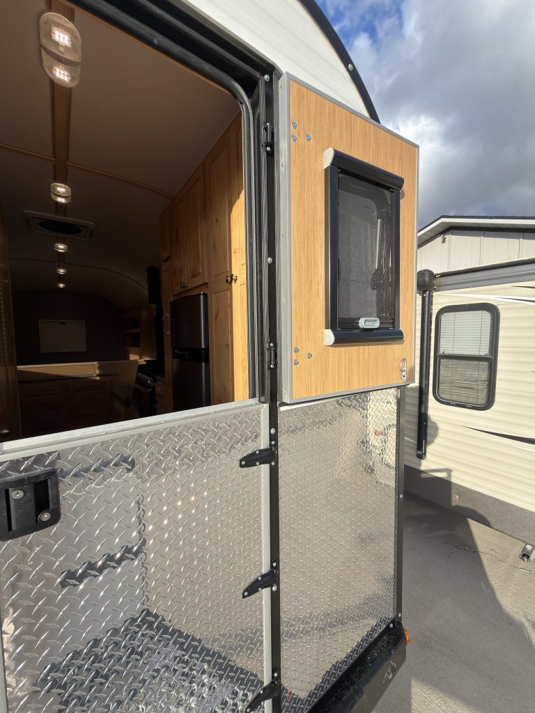 Van Niewkoop Camp #136: Exterior view of the Dutch entry door with its upper half open.