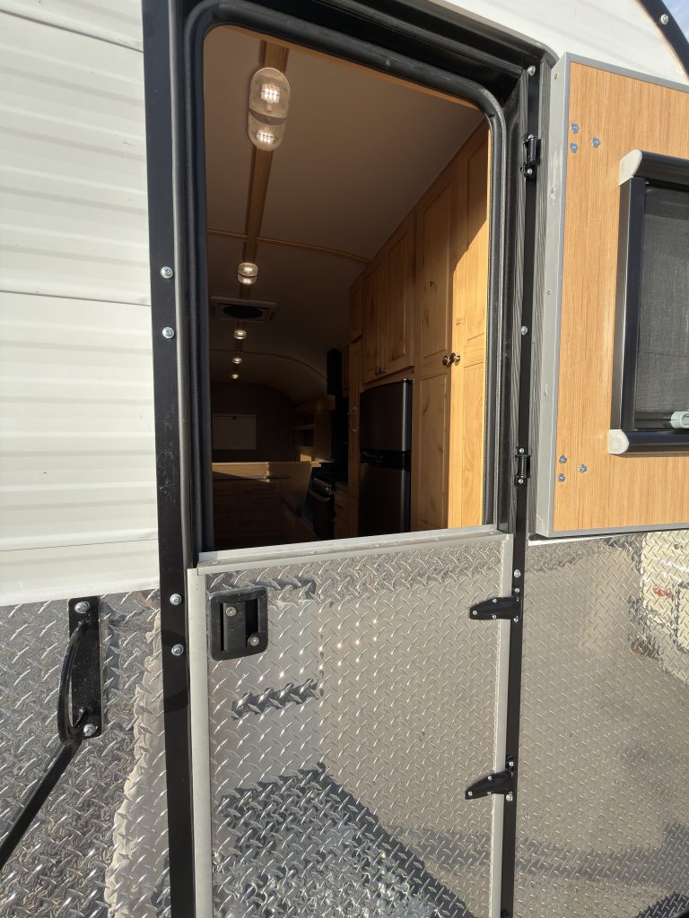 Van Niewkoop Camp #136: Upper half of the Dutch entry door open above the closed lower panel.