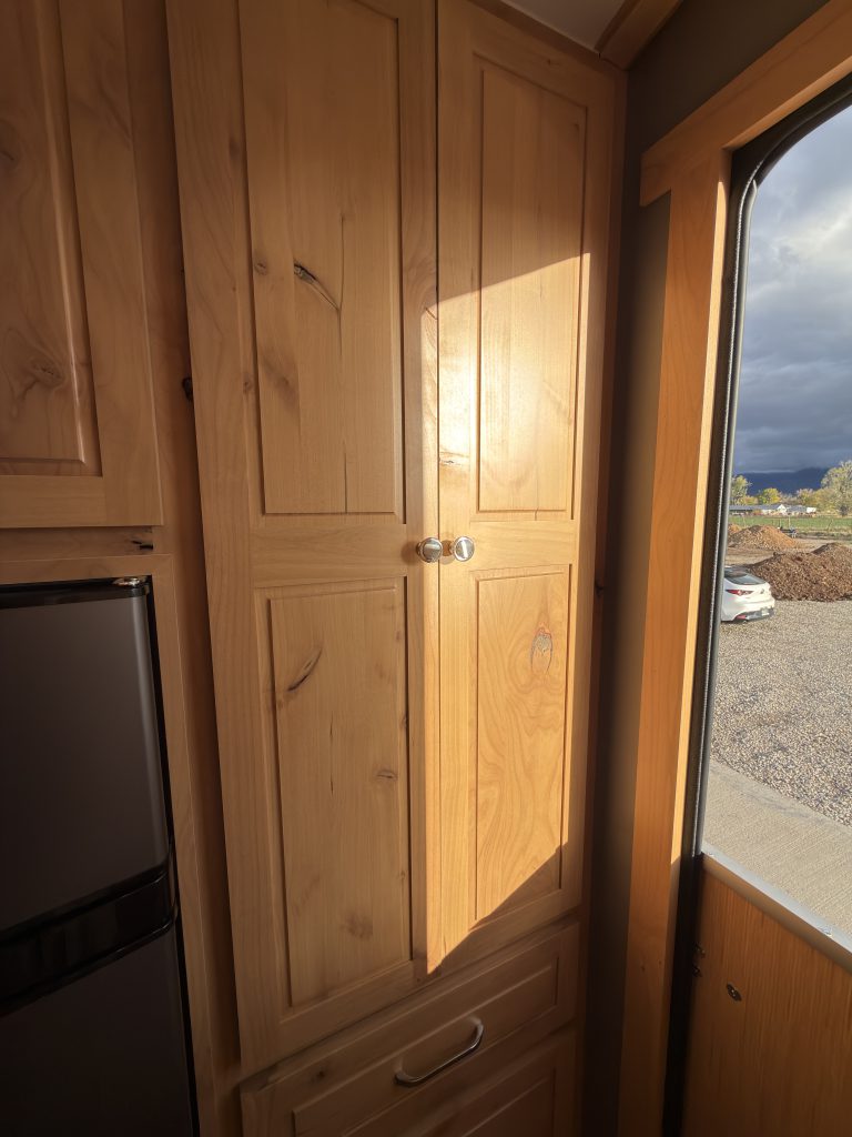 Van Niewkoop Camp #136: Tall hardwood entry closet beside the Dutch doorway.