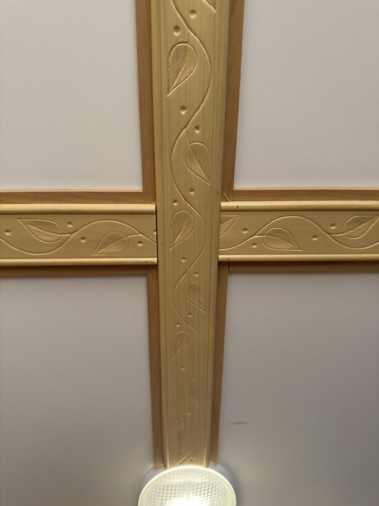 Van Niewkoop Camp #136: Close view of carved rosewood trim crossing the curved interior ceiling.