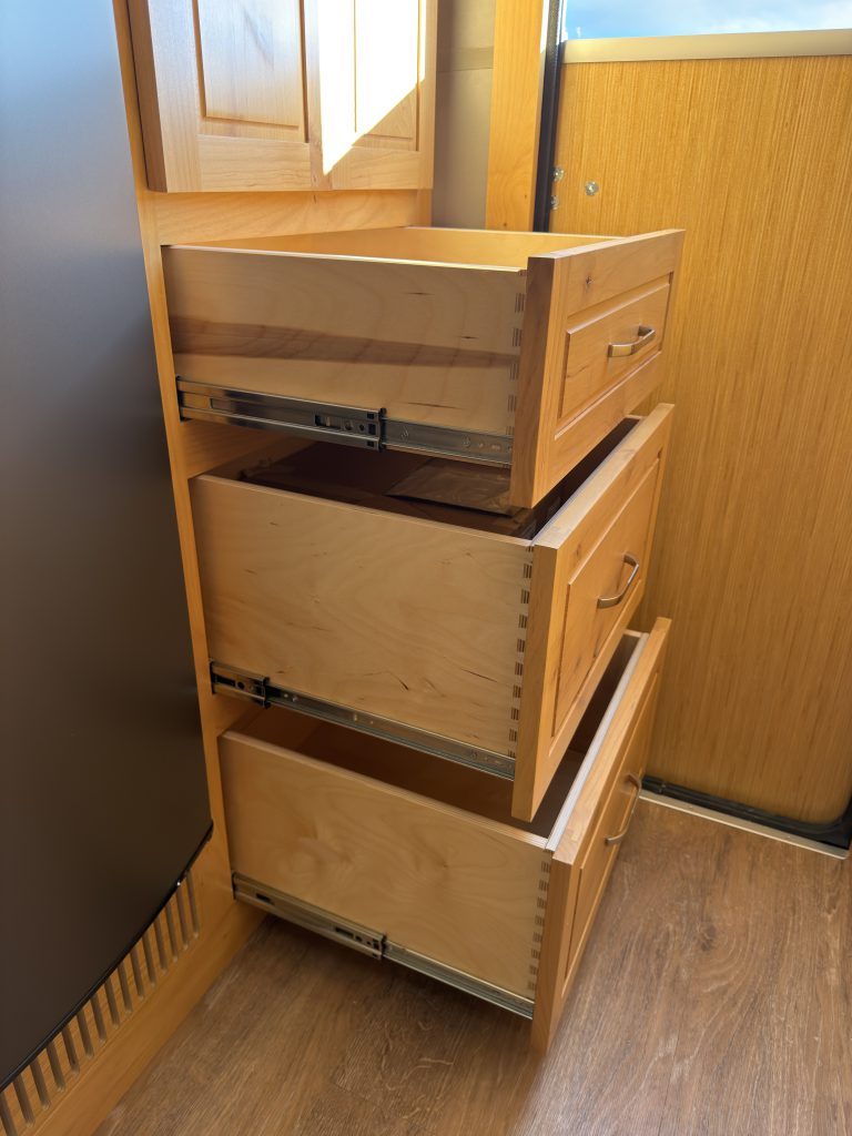 Van Niewkoop Camp #136: Three large wood drawers extended beneath the entry closet.