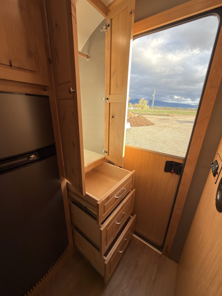 Van Niewkoop Camp #136: Entry closet and its three large drawers opened beside the Dutch doorway.